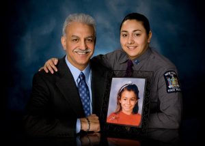 Ahmad Rivazfar and daughter Sayeh, an officer with the New York State Police. With them is a picture of Ahmad’s daughter, Sara Rivazfar, who was murdered by her mother’s boyfriend on September 22, 1988.